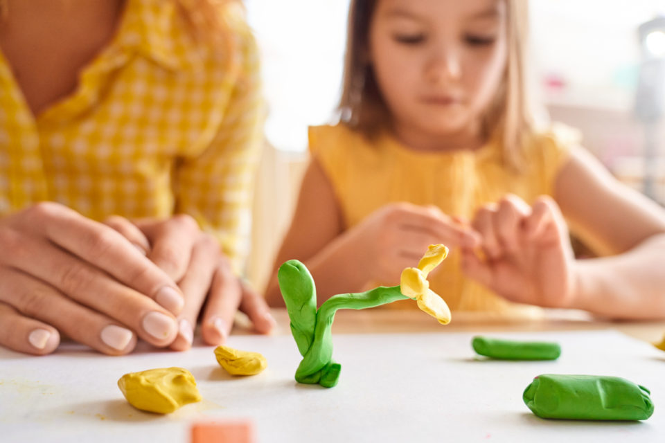 Mother and daughter crafting a flower