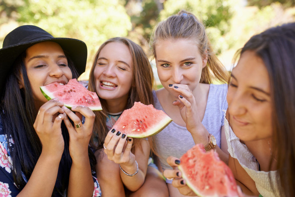 Shot of teenage girls eating watermelon